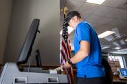 Ryan Bedford puts a ballot into a machine while voting Tuesday, Aug. 9, 2022, at the Village of Waukesha Municipal Complex. Angela Major/WPR