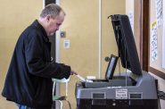Milwaukee resident Troy Boeldt inserts his ballot into a reading machine after filling it out Tuesday, April 5, 2022, at the Milwaukee French Immersion School in Milwaukee, Wis. Angela Major/WPR